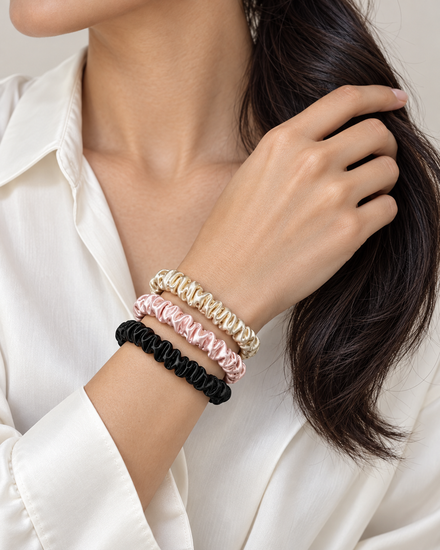 Close-up of three satin scrunchies on a wrist